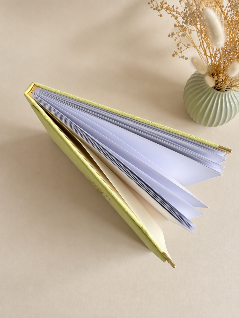 Kollane sametine fotoalbum Kollane sametine fotoalbum valgete lehtede, kuldsete nurgakaitsmete ja minimalistliku lillemustriga kaanel.